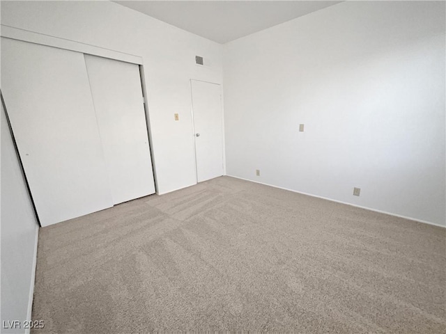 unfurnished bedroom featuring a closet and carpet