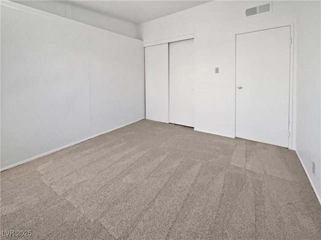 unfurnished bedroom with a closet and carpet