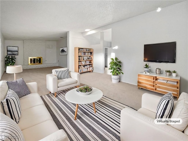 living room with a brick fireplace, a textured ceiling, and carpet floors