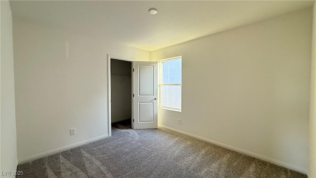 unfurnished bedroom featuring a closet, carpet flooring, and baseboards