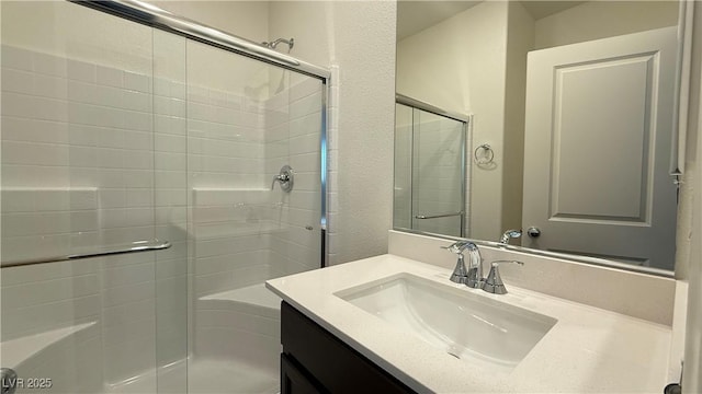 full bathroom featuring vanity and a shower with shower door