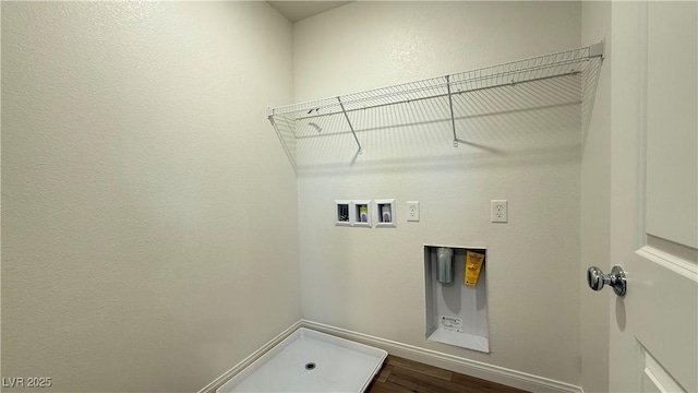 clothes washing area featuring laundry area, washer hookup, and dark wood finished floors