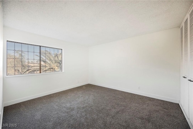 carpeted spare room featuring a textured ceiling