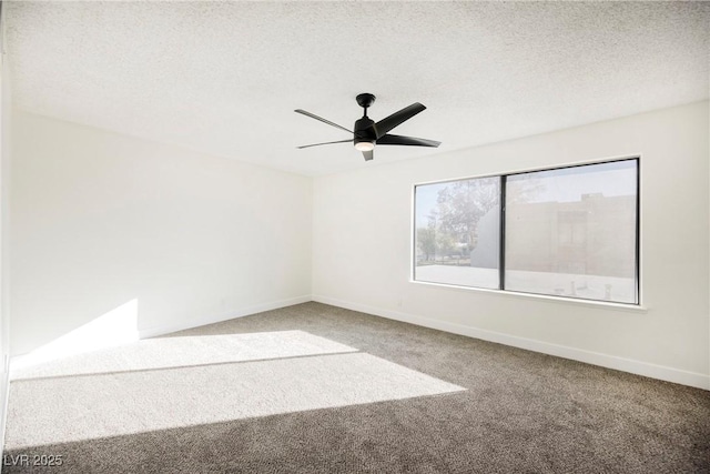 carpeted spare room with a textured ceiling and ceiling fan