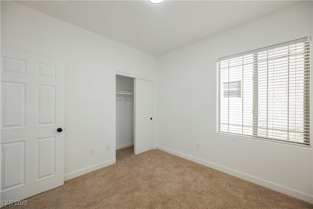 unfurnished bedroom featuring a closet, multiple windows, and carpet flooring