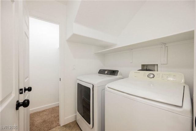 clothes washing area featuring washer and clothes dryer