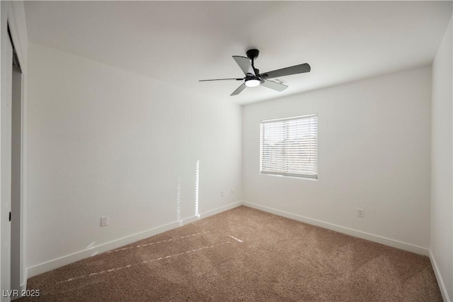 carpeted empty room featuring ceiling fan