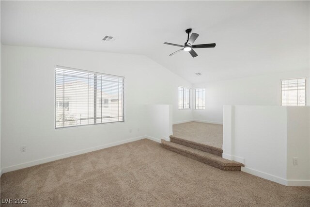 carpeted empty room with lofted ceiling and ceiling fan