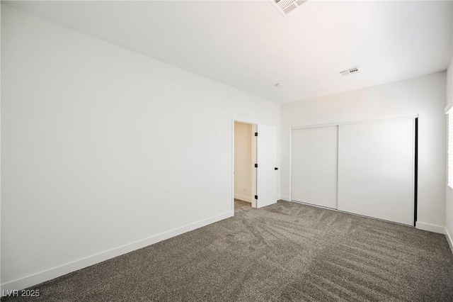 unfurnished bedroom featuring carpet floors and a closet