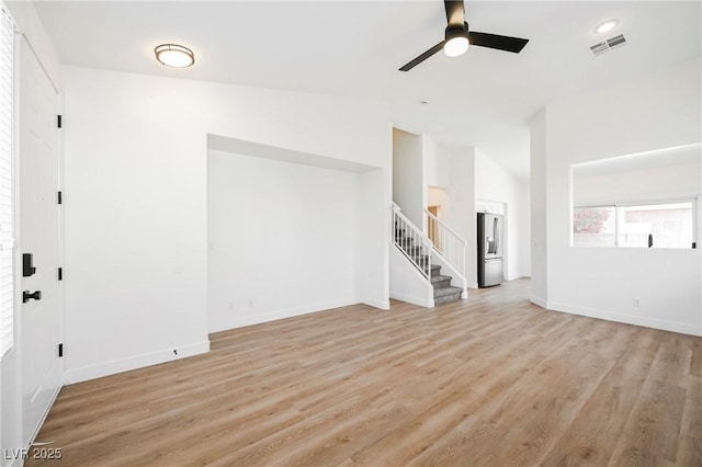 unfurnished room featuring lofted ceiling, light wood-type flooring, and ceiling fan