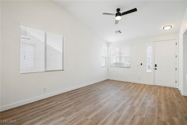 foyer with lofted ceiling, ceiling fan, and light hardwood / wood-style flooring