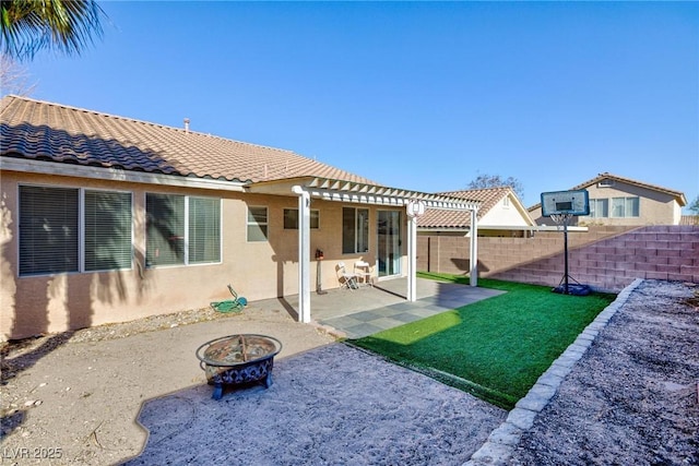 rear view of property featuring an outdoor fire pit, a patio, a lawn, and a pergola