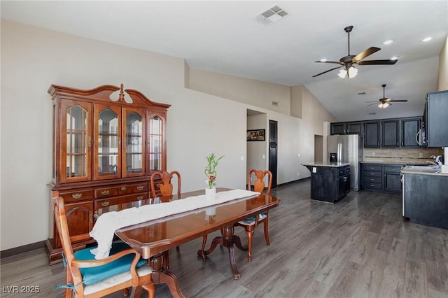 dining area featuring lofted ceiling, ceiling fan, and hardwood / wood-style flooring