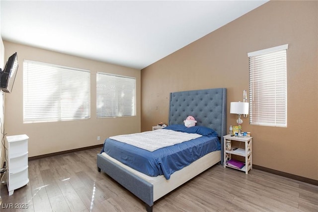 bedroom featuring hardwood / wood-style flooring and vaulted ceiling