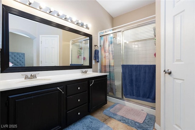 bathroom with vanity, a shower with door, and tile patterned flooring