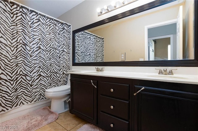 bathroom featuring curtained shower, tile patterned flooring, vanity, and toilet