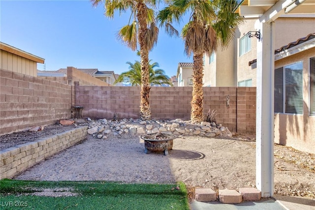 view of yard with an outdoor fire pit