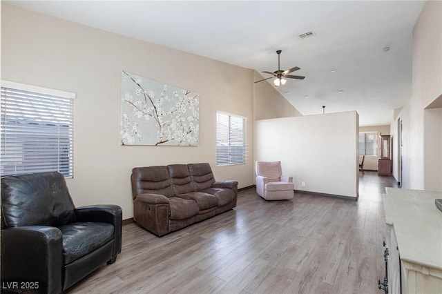 living room featuring high vaulted ceiling, ceiling fan, and light hardwood / wood-style floors