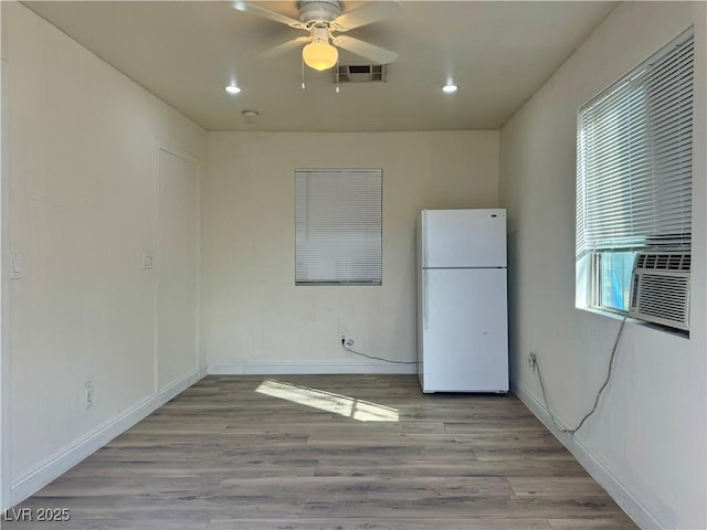 spare room with light wood-type flooring and ceiling fan