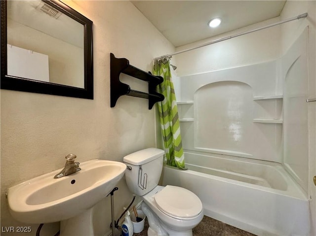 bathroom featuring toilet and shower / bath combo