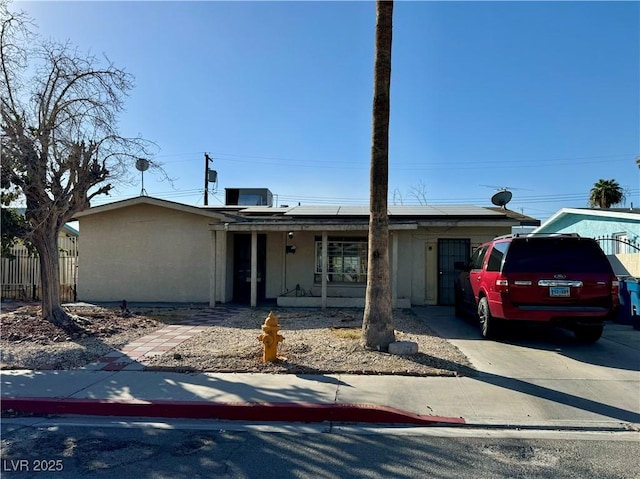 view of front of property featuring covered porch and solar panels