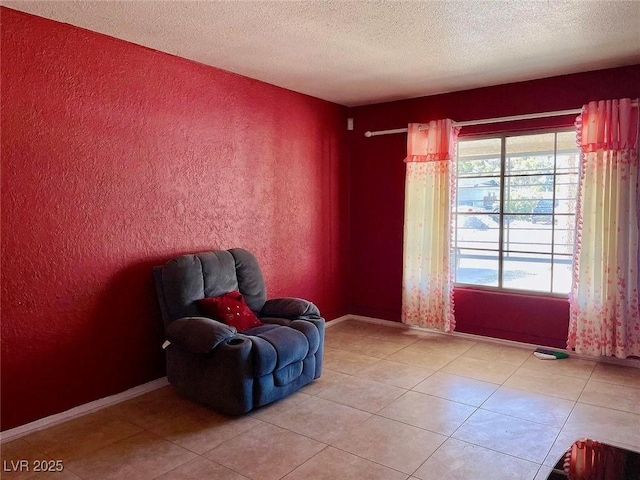 living area featuring light tile patterned flooring and a textured ceiling