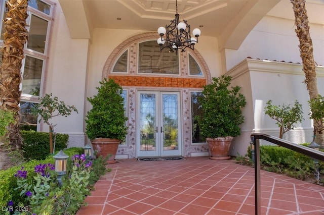 entrance to property featuring french doors and stucco siding