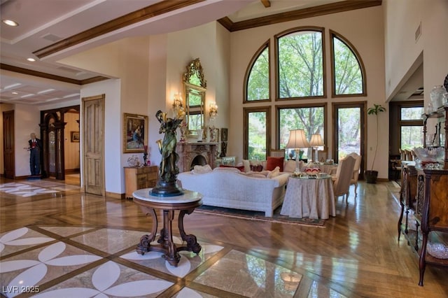 living area featuring crown molding, recessed lighting, a fireplace, and baseboards