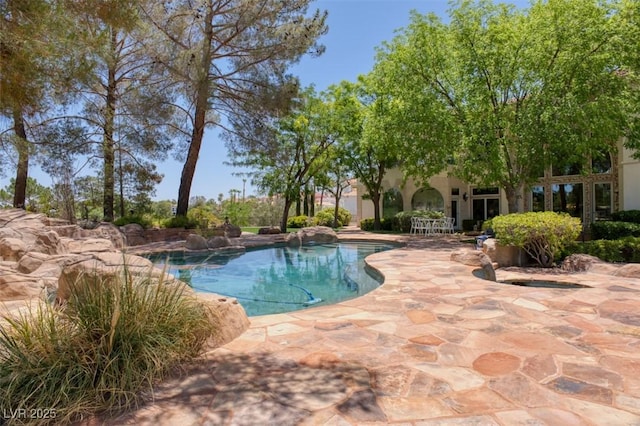 outdoor pool with a patio area