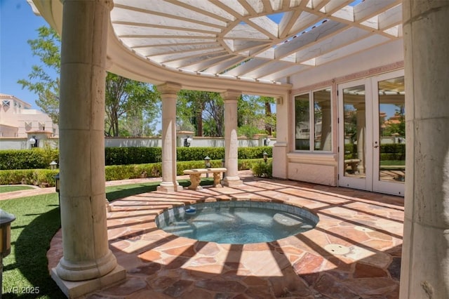 exterior space featuring french doors and an in ground hot tub