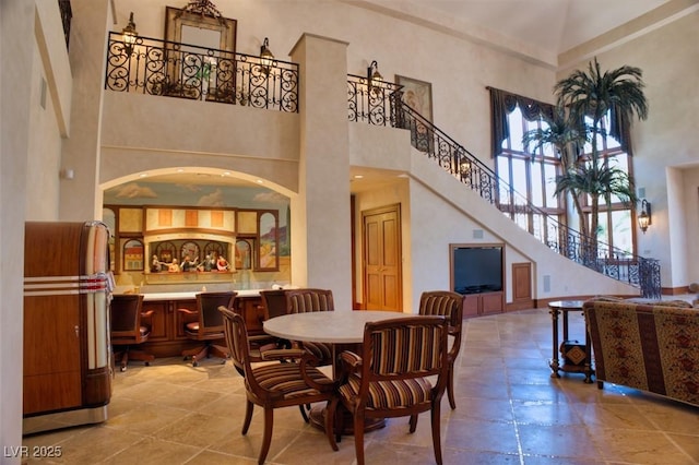 dining area with a high ceiling