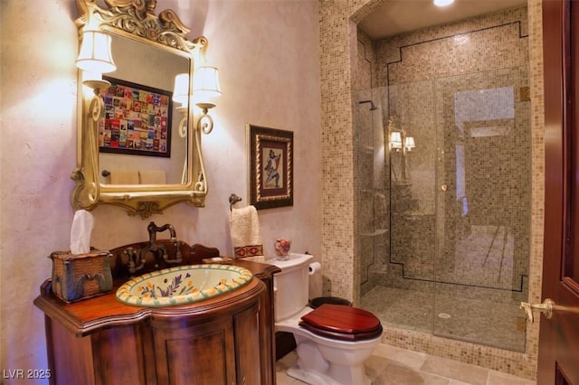 bathroom featuring a shower stall, toilet, and vanity