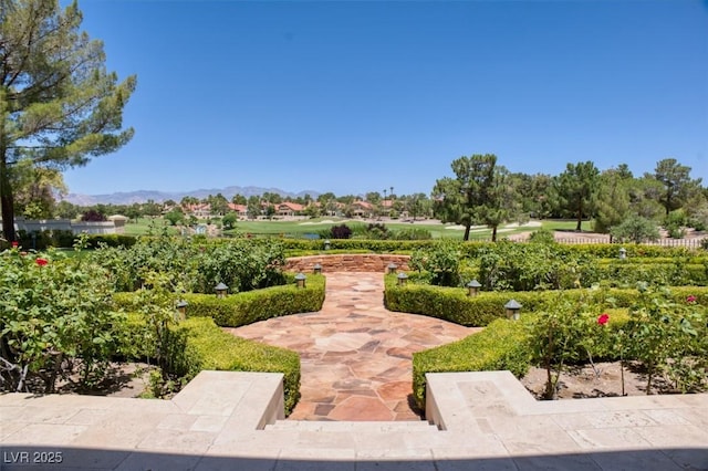 view of property's community with a patio and a mountain view