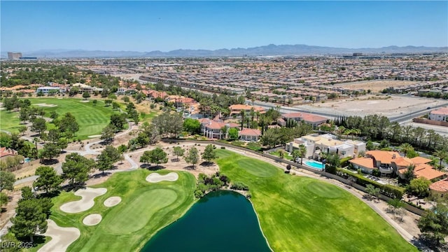 drone / aerial view featuring view of golf course and a water and mountain view