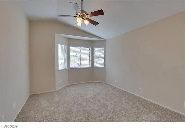 spare room featuring lofted ceiling, light carpet, and ceiling fan