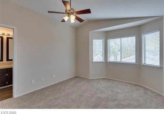 carpeted empty room featuring lofted ceiling and ceiling fan