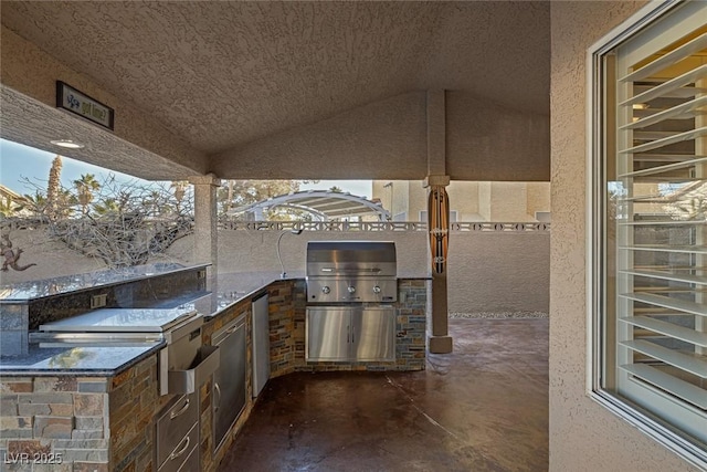 view of patio with a grill and an outdoor kitchen