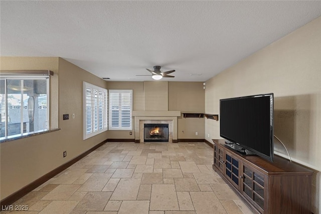 unfurnished living room featuring a tile fireplace and ceiling fan