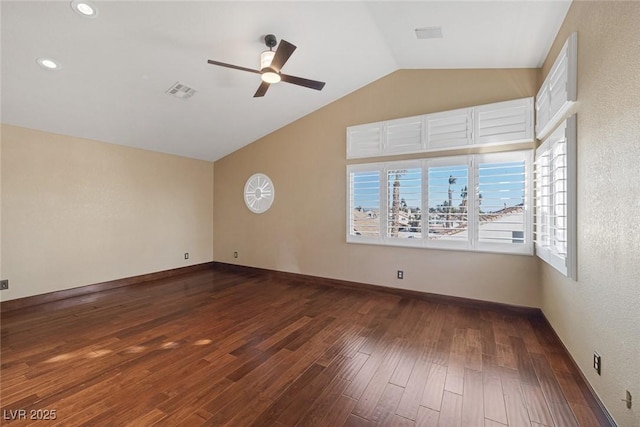 empty room featuring lofted ceiling, ceiling fan, and dark hardwood / wood-style flooring