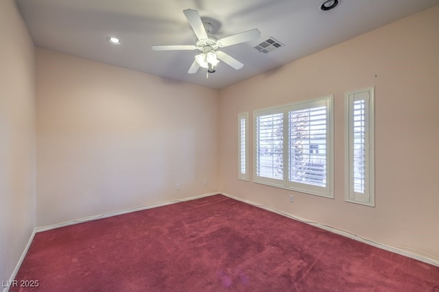 carpeted spare room featuring ceiling fan