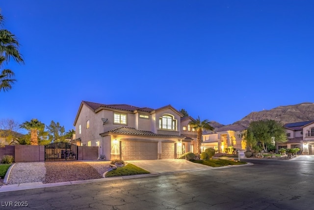 mediterranean / spanish home with a garage and a mountain view