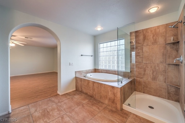 bathroom with ceiling fan, separate shower and tub, and tile patterned floors