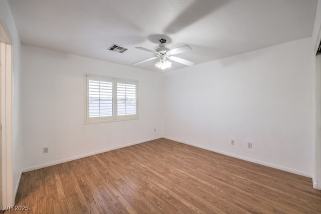 spare room with ceiling fan and hardwood / wood-style flooring