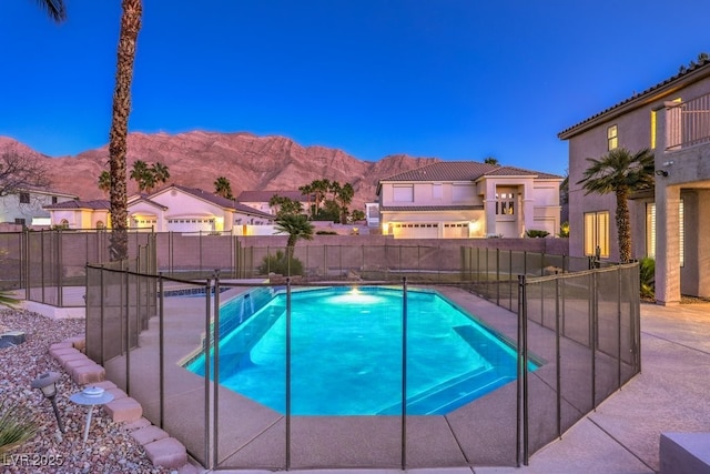 pool at dusk with a mountain view