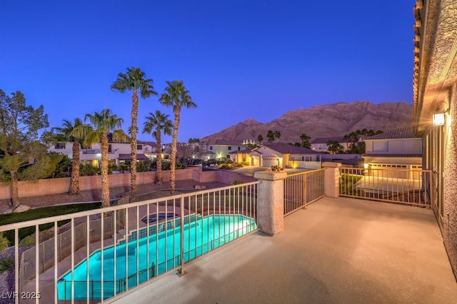 exterior space featuring a fenced in pool and a mountain view