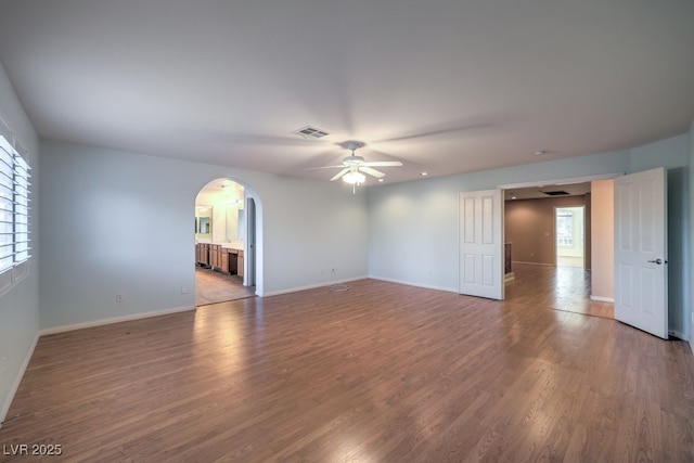 spare room with hardwood / wood-style floors and ceiling fan