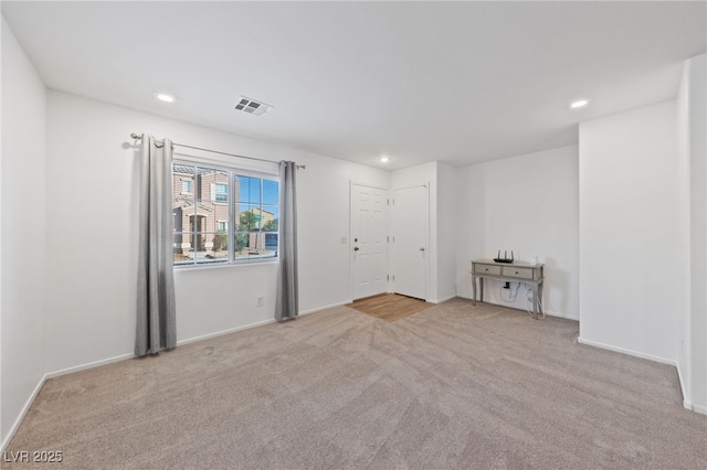 empty room with light carpet, visible vents, and recessed lighting