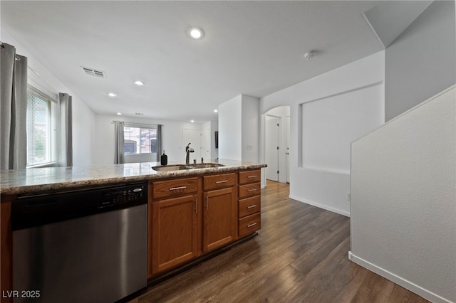 kitchen featuring light stone counters, stainless steel dishwasher, dark hardwood / wood-style floors, and sink