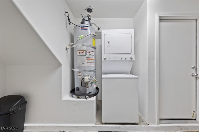 laundry room with stacked washing maching and dryer, strapped water heater, and laundry area