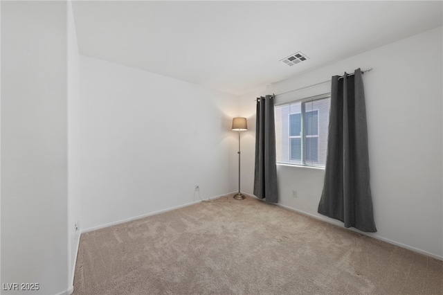 empty room with light colored carpet and visible vents